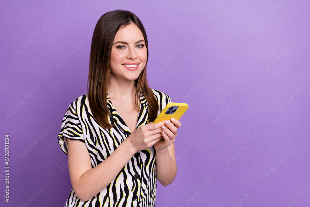 Portrait of pretty positive person toothy smile use smart phone empty space advert isolated on purple color background Portrait of pretty positive person toothy smile use smart phone empty space advert isolated on purple color background
