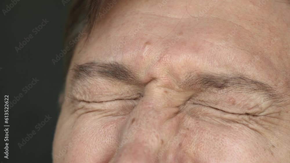 Close-up of a middle-aged man tightly closing eyes feeling suffering or pain. The concept of a man's life crisis, health problems and sad news 4K Close-up of a middle-aged man tightly closing eyes feeling suffering or pain. The concept of a man's life crisis, health problems and sad news 4K