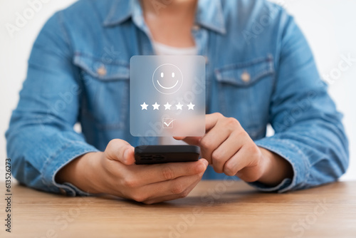 customer satisfaction survey concept business people use smartphone Touch the happy smiley icon. Satisfied. 5 stars. Service experience rating. online application Satisfaction Review best quality.