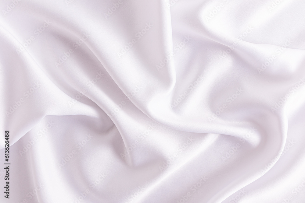 Delicate texture of white satin fabric with soft waves. Elegant white wedding background. layout for design.