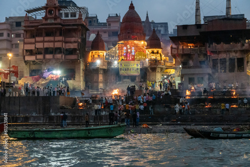 India Varanasi ganga ghat at night, view of the crowded banks of people and funeral pyres photo