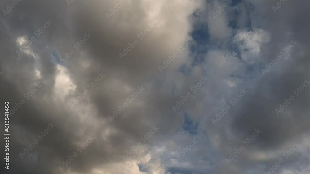 Golden cumulus clouds in the sky moving in a heavenly landcape at sunset Golden cumulus clouds in the sky moving in a heavenly landcape at sunset