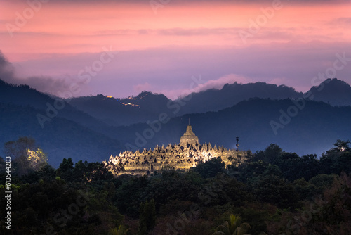 magnificent borobudur temple at sunset with mountain range in background photo