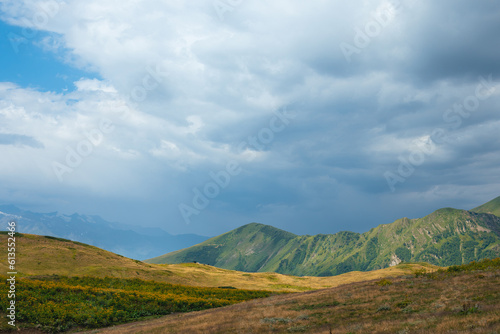 View of mountain tops, warm summer day, clouds in the sky, way to Ushba mountain and Koruldi lakes. Concept of vacation and travel to Georgia. Nature, Mestia, Svaneti mountains © Sergey