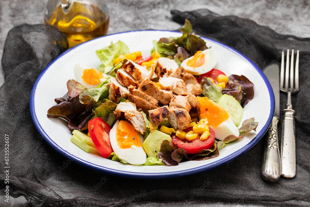 Delicious light vegetable salad made from tomatoes, canned corn, cucumber, lettuce, avocado, boiled egg andchicken Delicious light vegetable salad made from tomatoes, canned corn, cucumber, lettuce, avocado, boiled egg andchicken