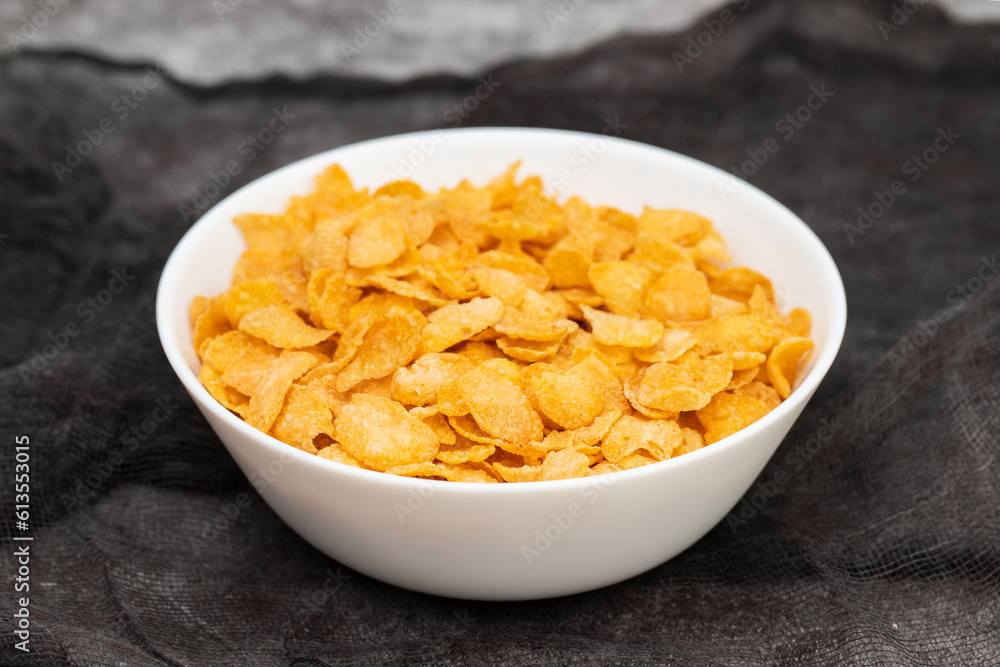 few corn flakes in white big bowl few corn flakes in white big bowl