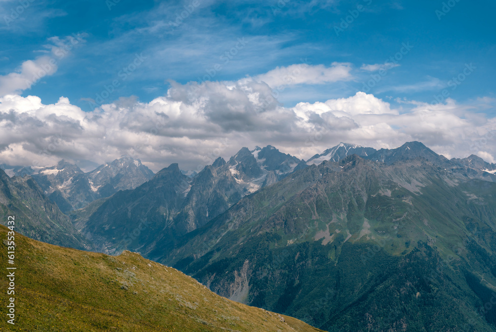 View of mountain tops, warm summer day, clouds in the sky, way to Ushba mountain and Koruldi lakes. Concept of vacation and travel to Georgia. Nature, Mestia, Svaneti mountains