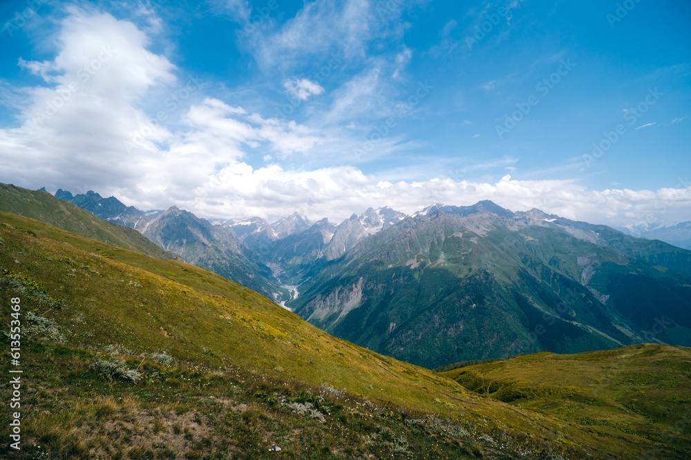 View of mountain tops, warm summer day, clouds in the sky, way to Ushba mountain and Koruldi lakes. Concept of vacation and travel to Georgia. Nature, Mestia, Svaneti mountains