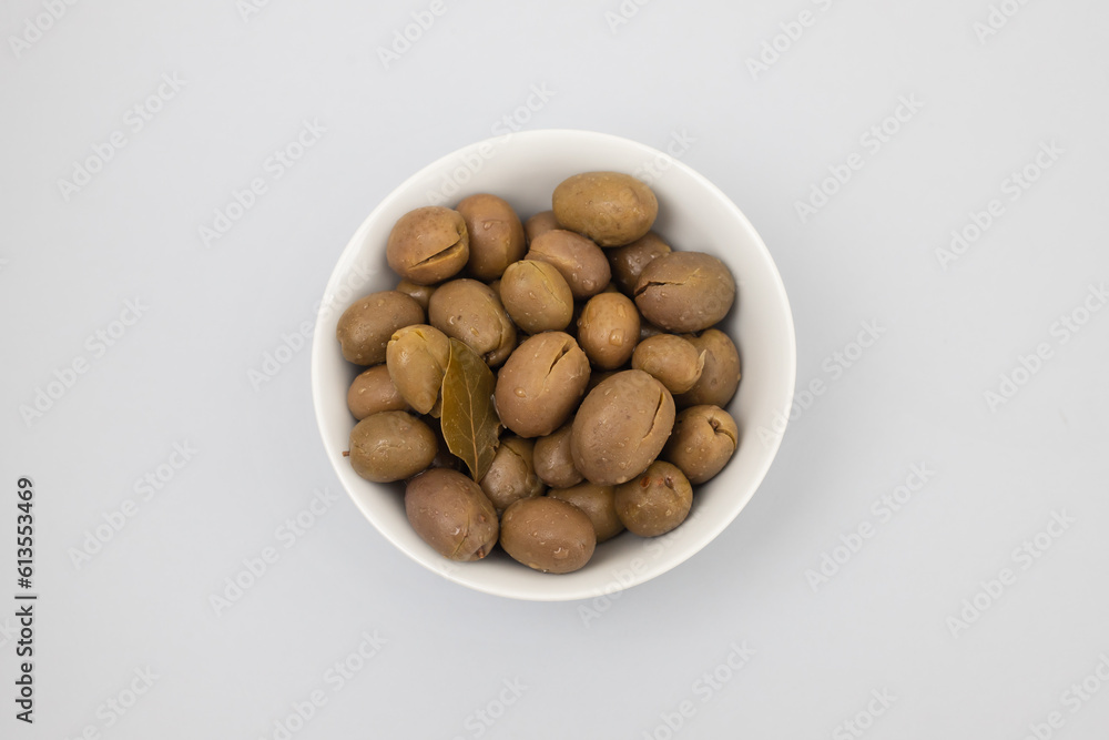 green olives in bowl in white small bowl green olives in bowl in white small bowl