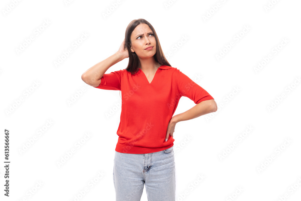 30 year old caucasian woman with straight dark hair is dressed in a red shirt on a white background with copy space 30 year old caucasian woman with straight dark hair is dressed in a red shirt on a white background with copy space