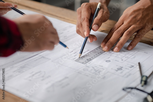 The home design architects are reviewing the house plan draft, the project commissioned by the client, and the custom design before delivery. Interior design and decoration ideas.