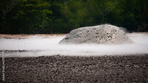 mud volcano with bursting bubble bledug kuwu. volcanic plateau with geothermal activity and geysers, slow motion Indonesia java. volcanic landscape photo