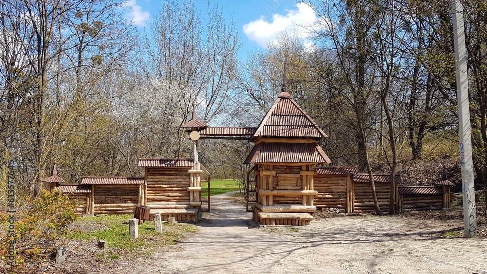 Log building at the entrance to the landscape park. Traditional architectural style design. Environmentally friendly building materials. Wooden bars in the urbanization of public space. Fire safety Log building at the entrance to the landscape park. Traditional architectural style design. Environmentally friendly building materials. Wooden bars in the urbanization of public space. Fire safety