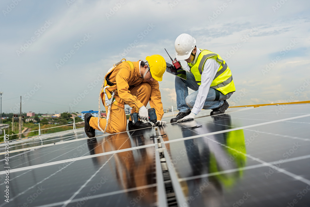 Engineers check the installation of solar panels on the factory roof, command engineers, supervise the installation of solar panels, engineers and technicians check the operation of solar panels. Engineers check the installation of solar panels on the factory roof, command engineers, supervise the installation of solar panels, engineers and technicians check the operation of solar panels.