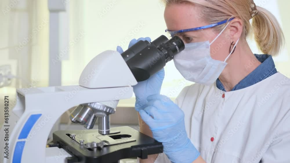 A laboratory assistant examines samples under a microscope. Scientific research in the laboratory. The concept of developing new medicines. Achievements in the field of biotechnology. A laboratory assistant examines samples under a microscope. Scientific research in the laboratory. The concept of developing new medicines. Achievements in the field of biotechnology.