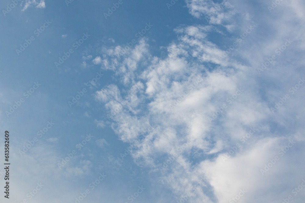 Clear sky with fluffy clouds background