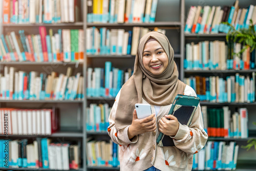 Portrait of asian muslim female student in a library
 photo