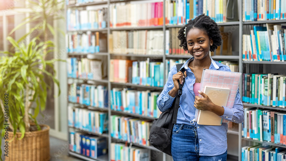 Portrait of black female student standing in a library
Portrait of black female student standing in a library