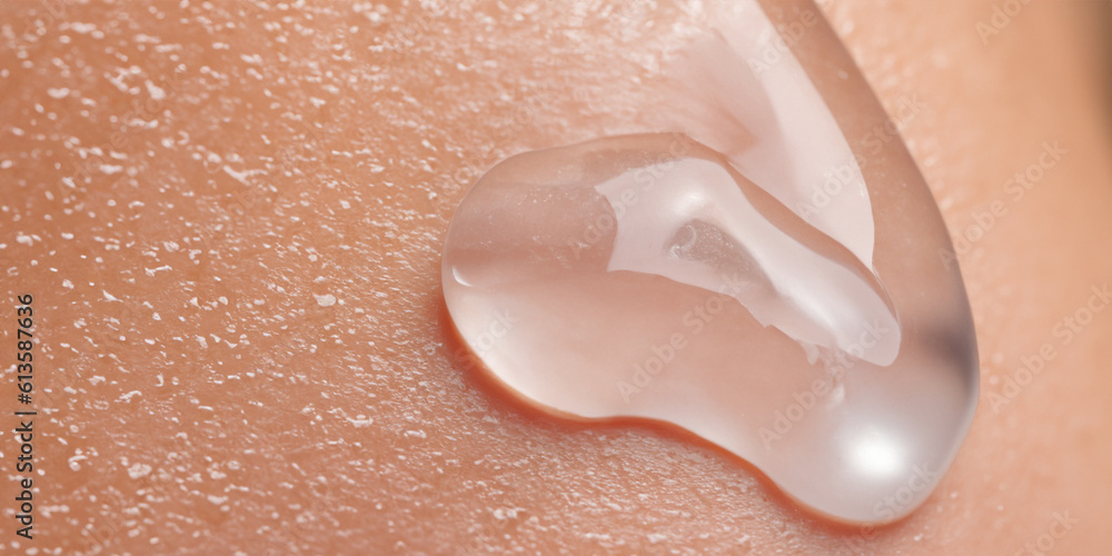 Fototapeta premium Collagen And Hyaluron Serum Gel On Skin. Splashing of Hyaluron gel. Liquid hyaluronic acid gel on skin. Cosmetic bubbles Gel texture on skin black background. Textured background. skin care product
