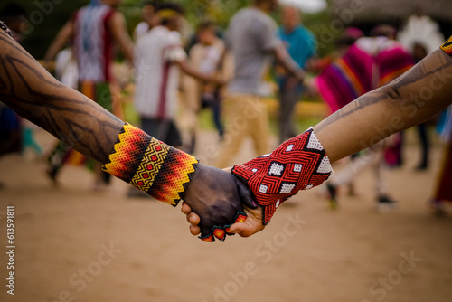 Stampa su tela Sao Paulo, SP, Brazil - April 20 2023: People holding hands wearing traditional colorful bracelets of indigenous peoples details