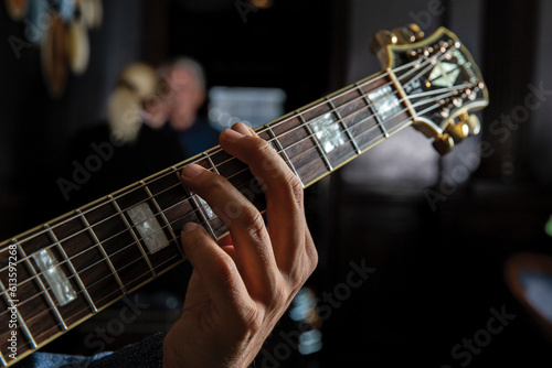 Guitar neck being played with fingers
