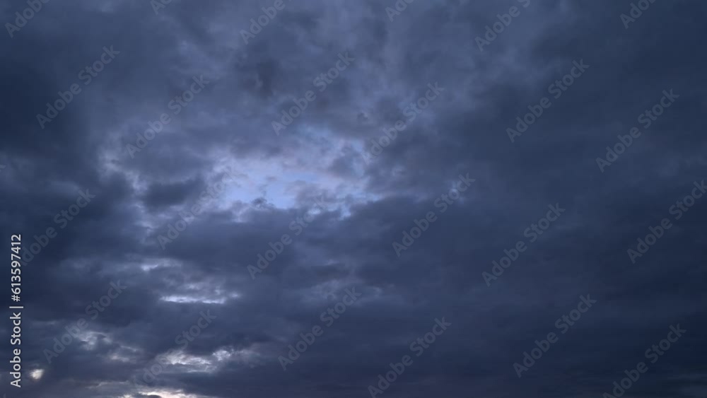 Purple-hued clouds move across the sky until they darken at dusk Purple-hued clouds move across the sky until they darken at dusk