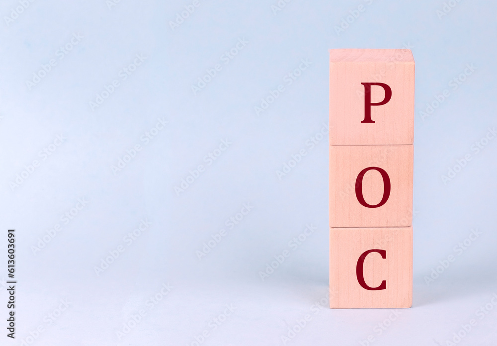 POC on wooden cubes on a blue background POC on wooden cubes on a blue background