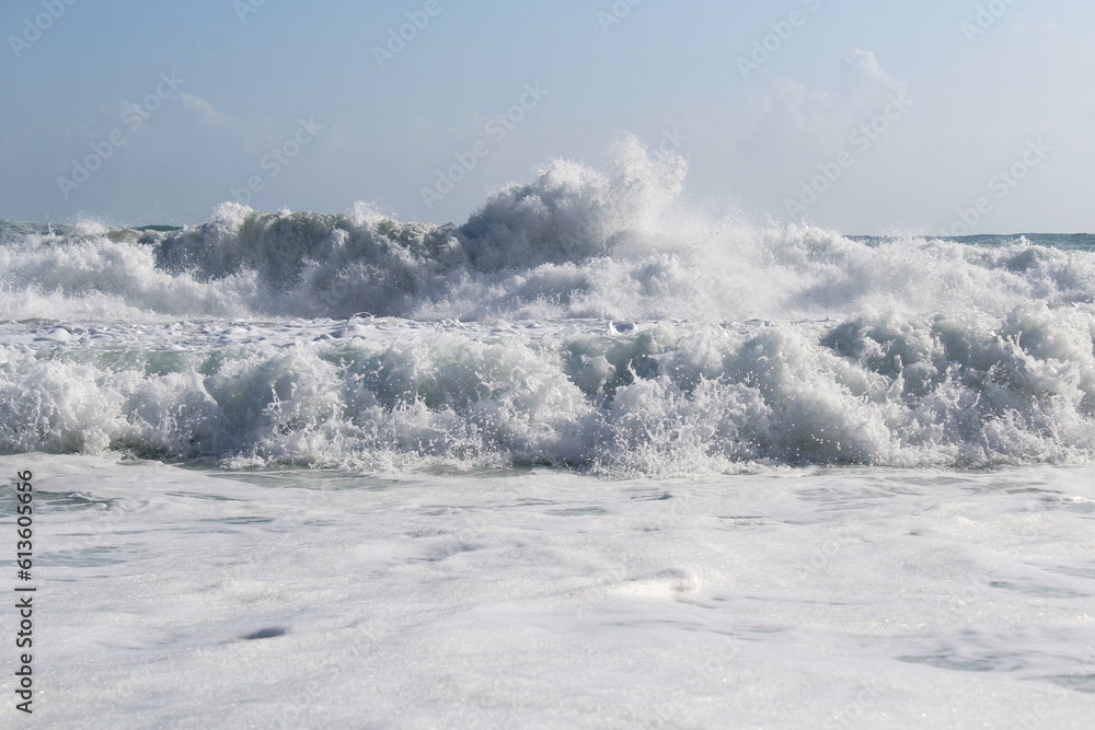 background splash white water waves isolated. wave splashing in the sea against a clear blue sky