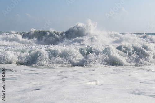 background splash white water waves isolated. wave splashing in the sea against a clear blue sky