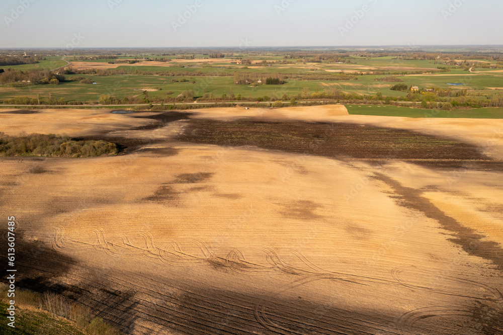 Fototapeta premium Drone photography of agricultural field and tractor tire tracks