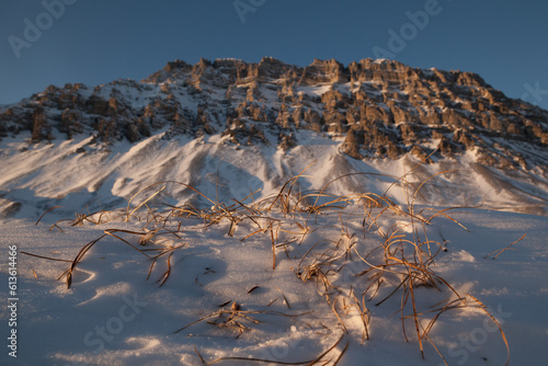 Frozen tundra and mountain range landscape in Alaska at sunset