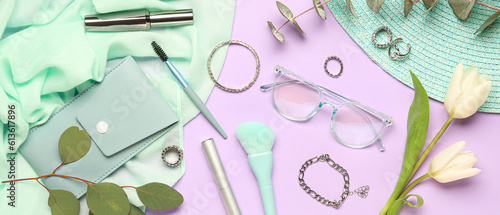 Composition with stylish female accessories and makeup cosmetics on lilac background