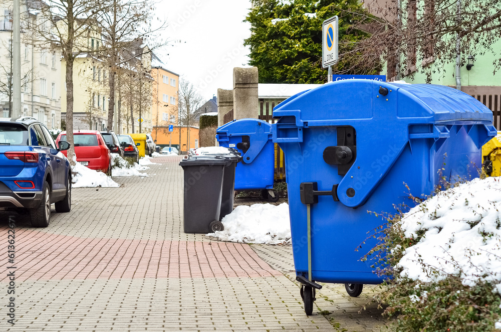 View of garbage containers in city on winter day View of garbage containers in city on winter day