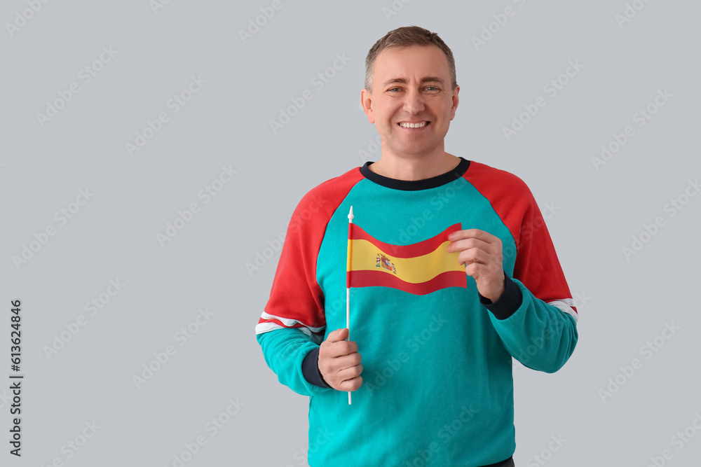 Mature man with flag of Spain on light background Mature man with flag of Spain on light background