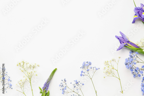 Frame made of beautiful flowers on white background