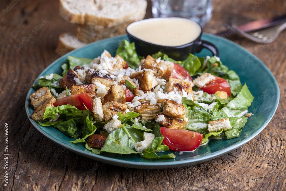 caesar salad on a green plate