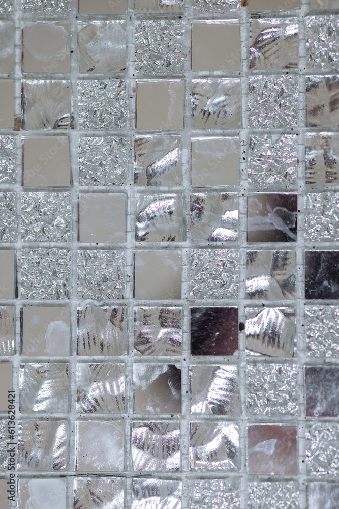 pattern of silver and mirror square tiles on the wall. High quality photo
