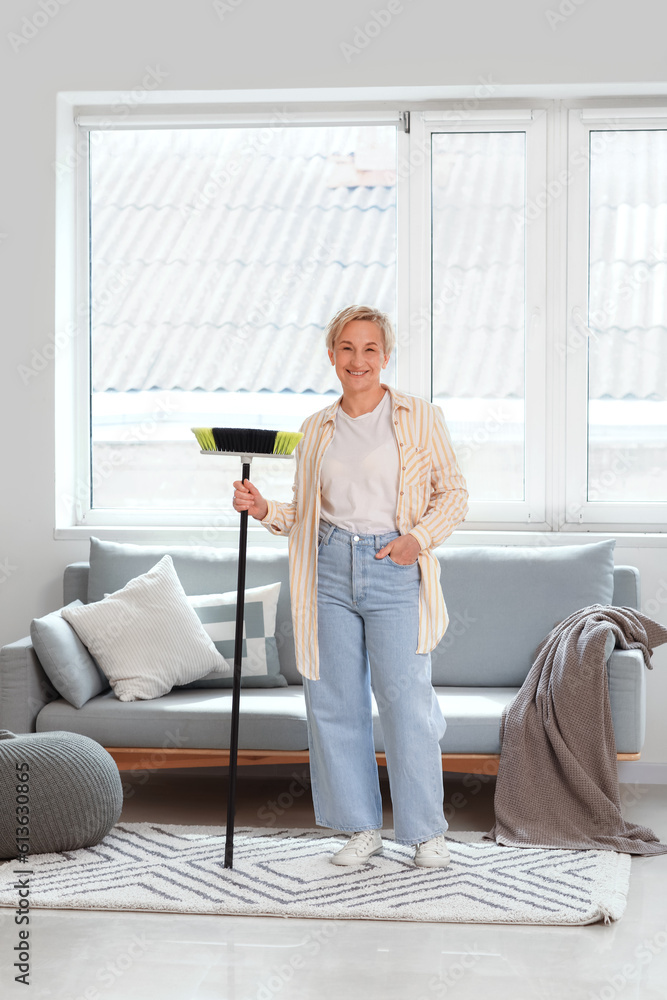 Mature woman with floor brush in room Mature woman with floor brush in room