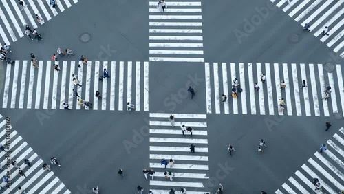 Aerial view of pedestrians walk crossing road intersection junction in downtown. Tokyo, Japan.