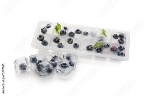 Fototapeta Naklejka Na Ścianę i Meble -  Ice tray with fresh blueberry frozen in ice on white background