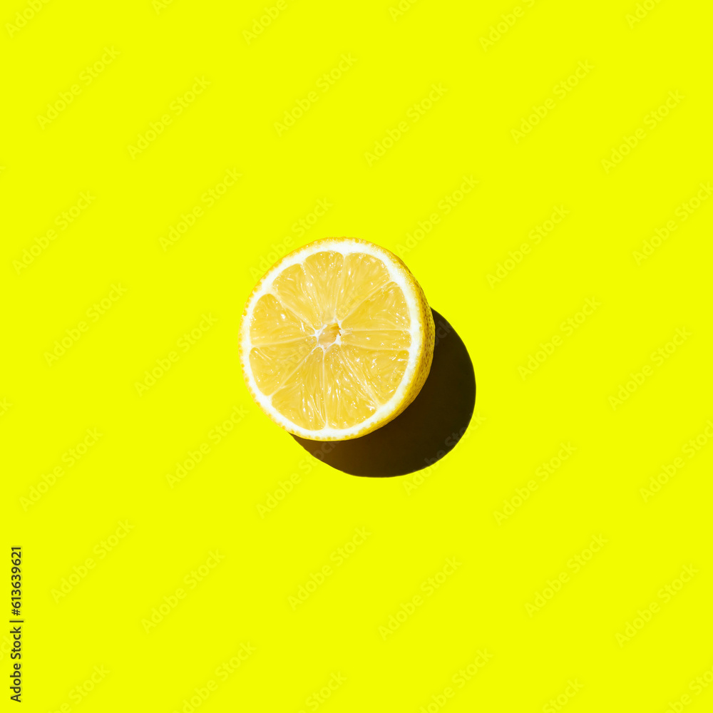 Fresh cut lemon lies on a yellow background isolate top view Fresh cut lemon lies on a yellow background isolate top view