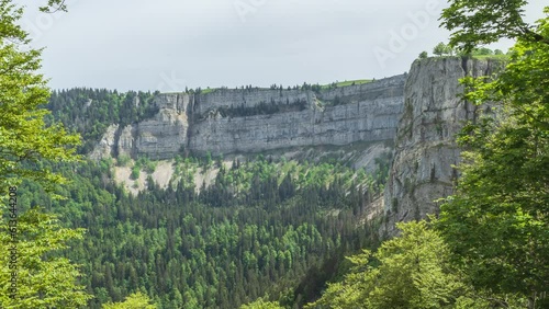 Timelapse, the steep cliffs of the amphitheatre shaped rocky cirque Creux Du Van, Jura Mountains. Located at the border of the cantons of Neuchatel and Vaud, Switzerland photo