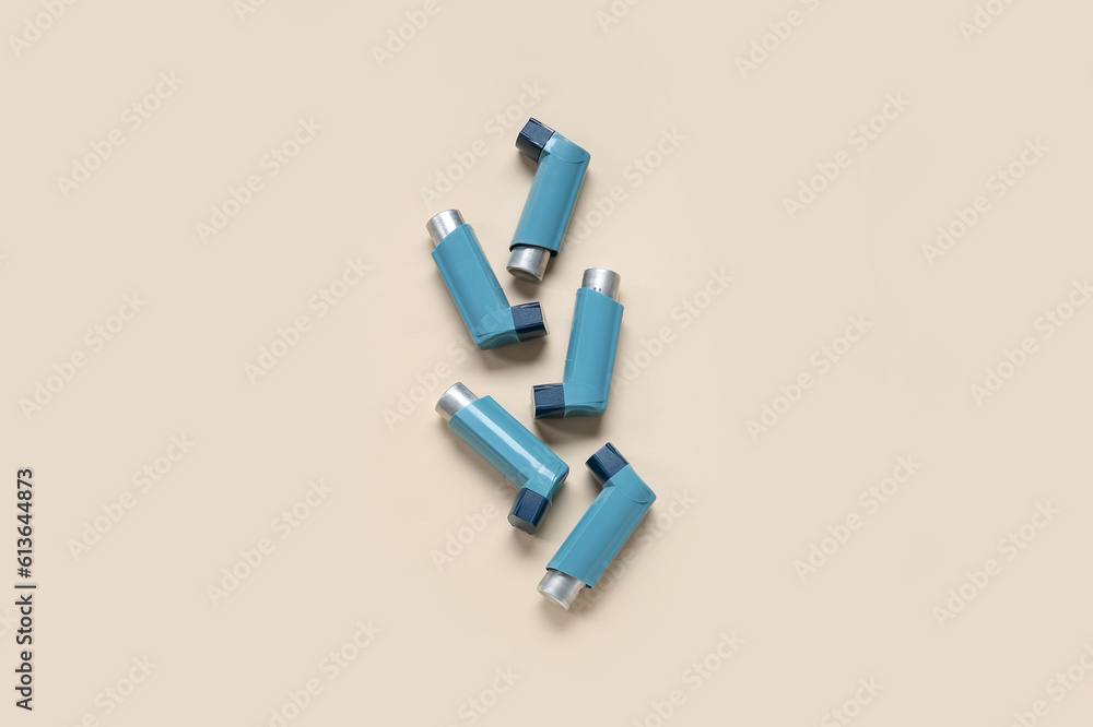 Asthma inhalers on beige background Asthma inhalers on beige background
