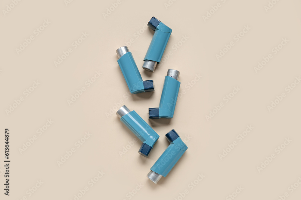 Asthma inhalers on beige background Asthma inhalers on beige background