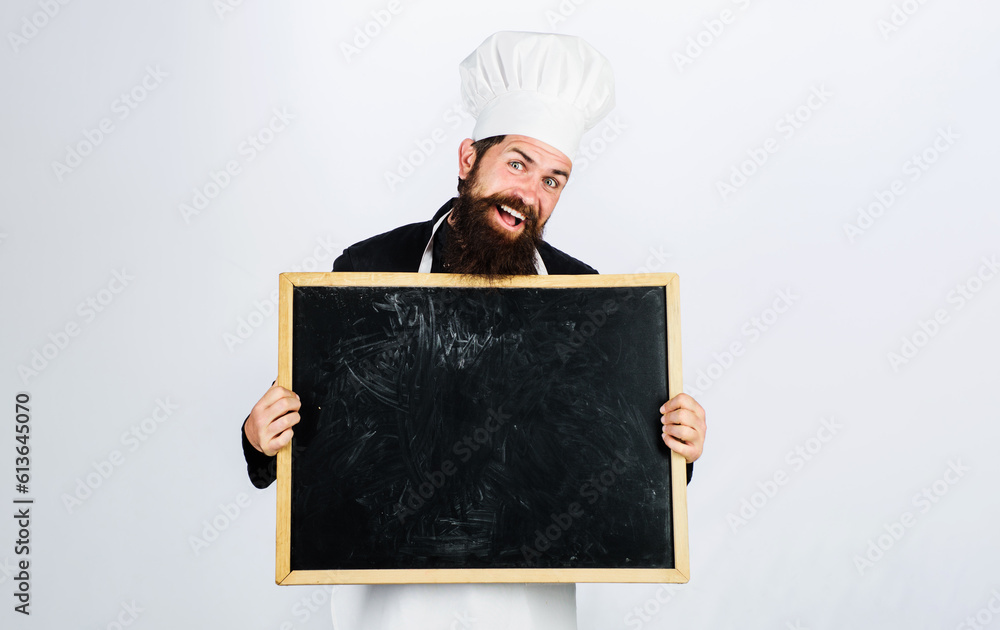 Smiling male chef with empty blackboard. Business lunch menu. Restaurant chef showing empty billboard with copy space for text. Male chef, cook or baker with blank poster for advertising healthy menu. Smiling male chef with empty blackboard. Business lunch menu. Restaurant chef showing empty billboard with copy space for text. Male chef, cook or baker with blank poster for advertising healthy menu.
