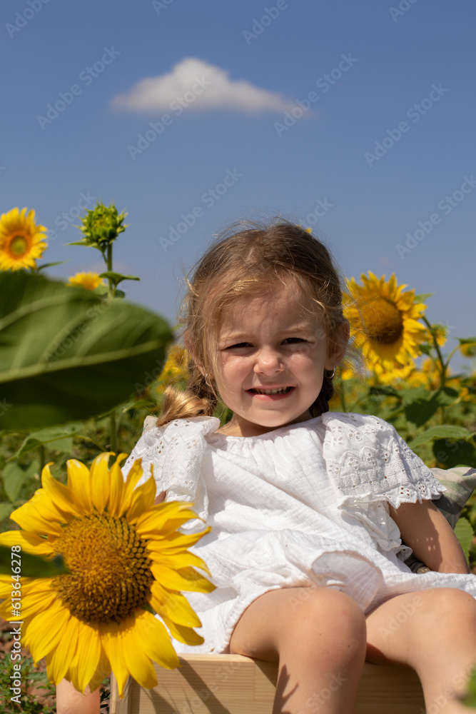 blond girl in the sunflowers enjoying nature blond girl in the sunflowers enjoying nature