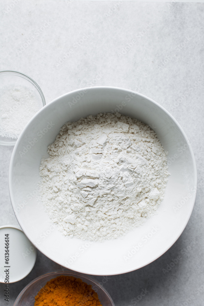 All purpose flour in a white bowl, baking flour in a large bowl All purpose flour in a white bowl, baking flour in a large bowl