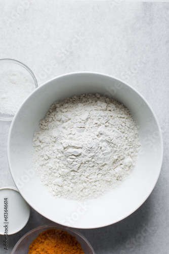 All purpose flour in a white bowl, baking flour in a large bowl