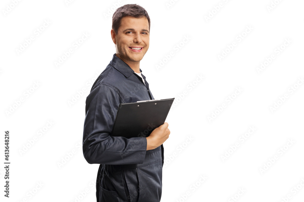 Auto mechanic holding a clipboard and smiling at camera Auto mechanic holding a clipboard and smiling at camera