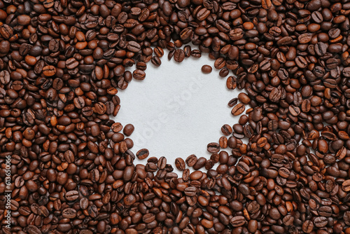 Frame made of coffee beans on light background